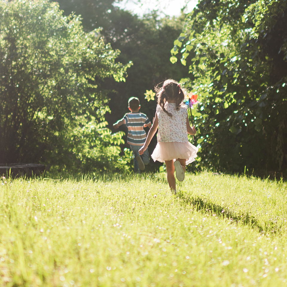 Kids running barefoot in lawn
