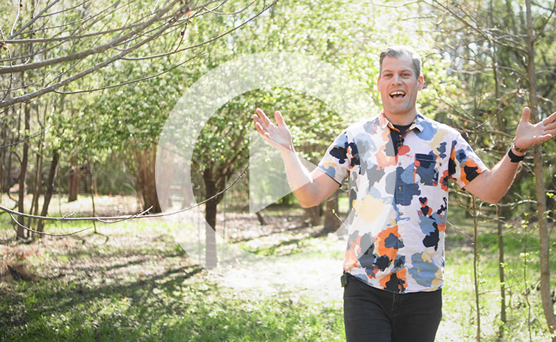 Basil Camu in a lush green forest canopy with sunlight filtering through